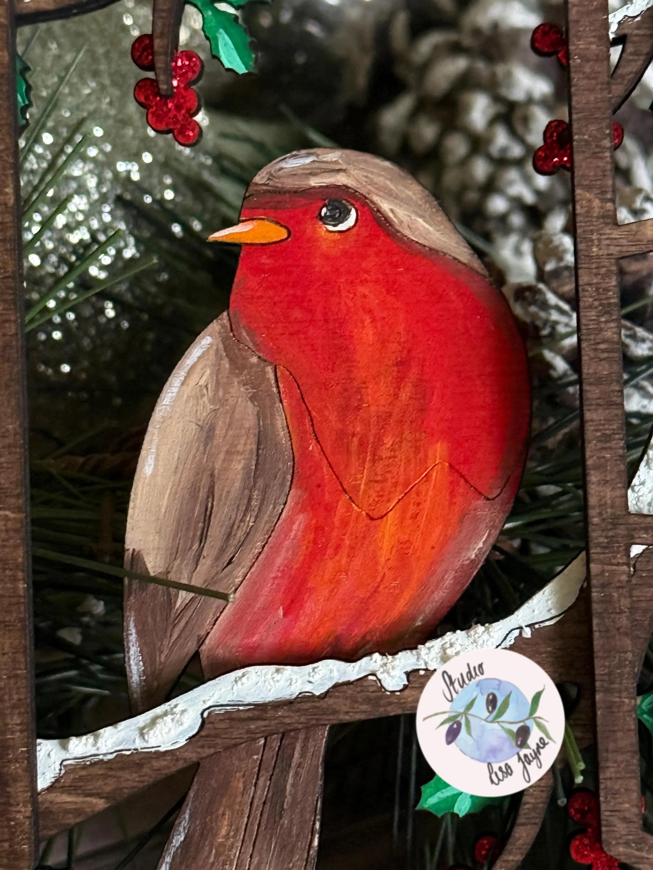 Wooden hand painted robin ornament with a natural background
