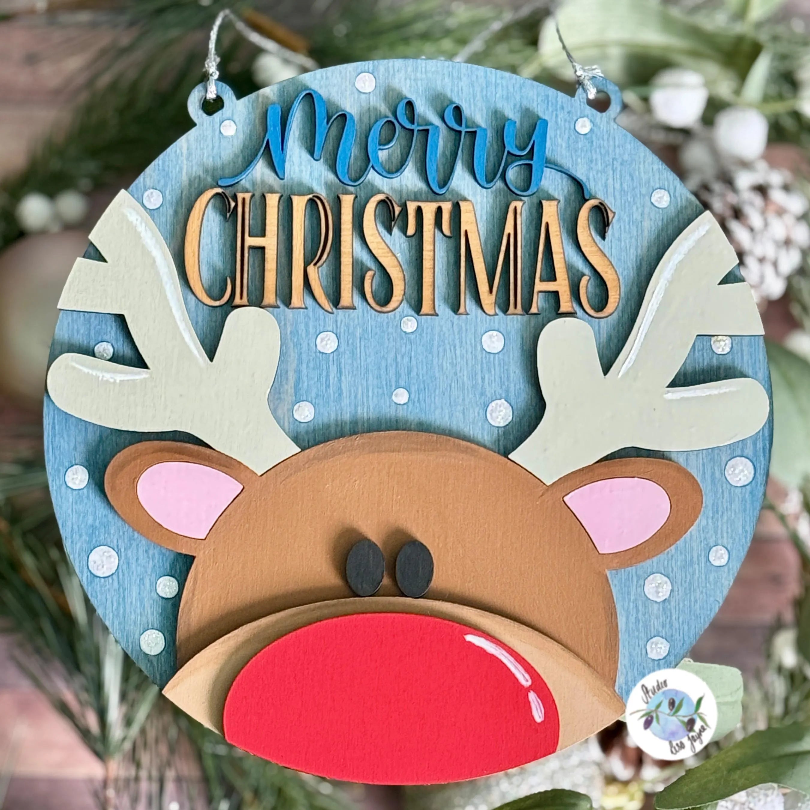 Decorative Christmas 20cm hanging sign with reindeer face and 'Merry Christmas' text on a blue background.