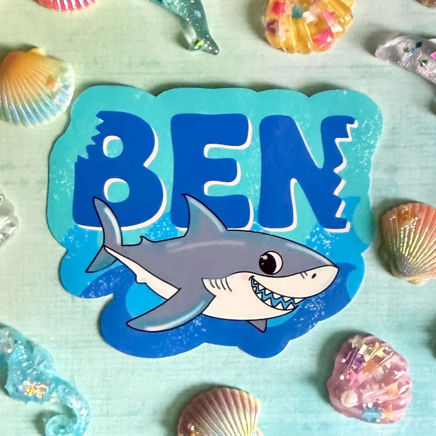 Sticker with a shark and the name 'Ben' surrounded by sea-themed decorations.