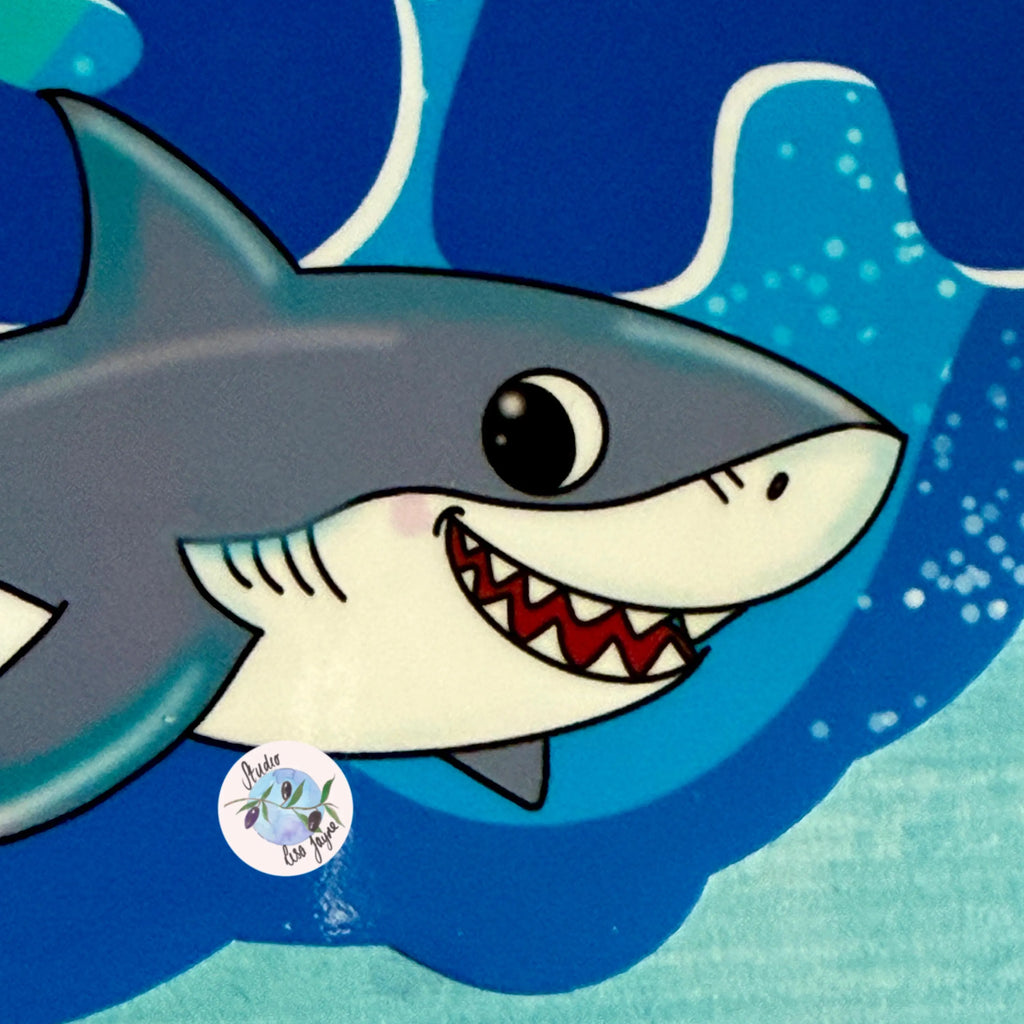 Cartoon shark with a blue background.  Close up of personalised name sticker 