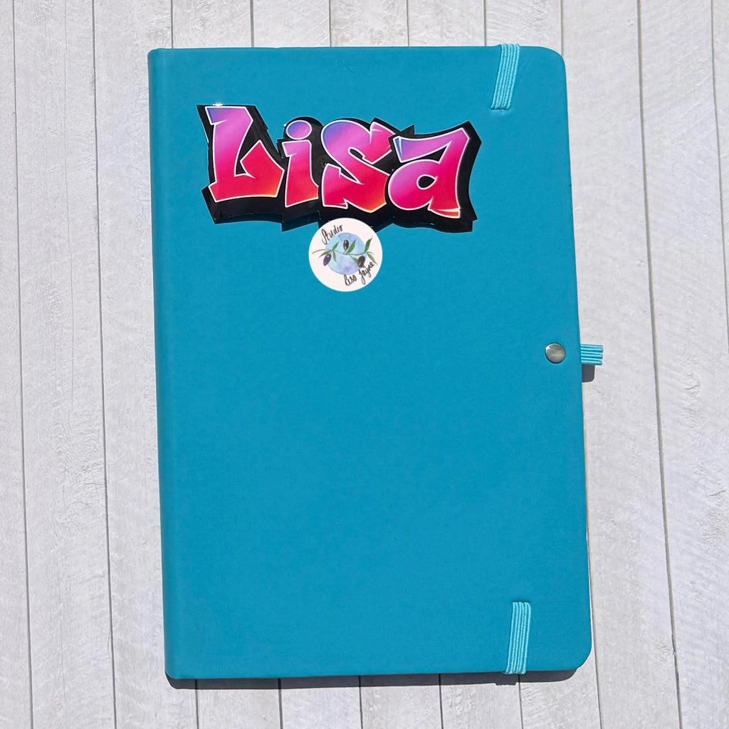 Blue notebook diary journal with a colorful 'Lisa' grafiti sticker with a purple and red gradient
