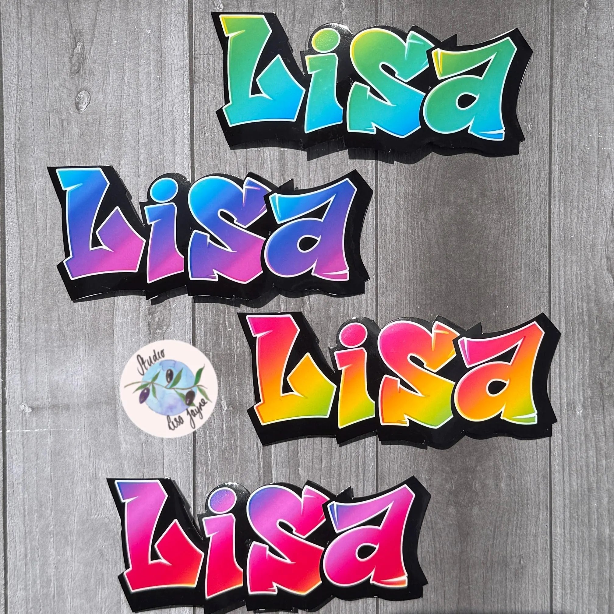 Colorful 'Lisa' graffitit style stickers on a wooden background