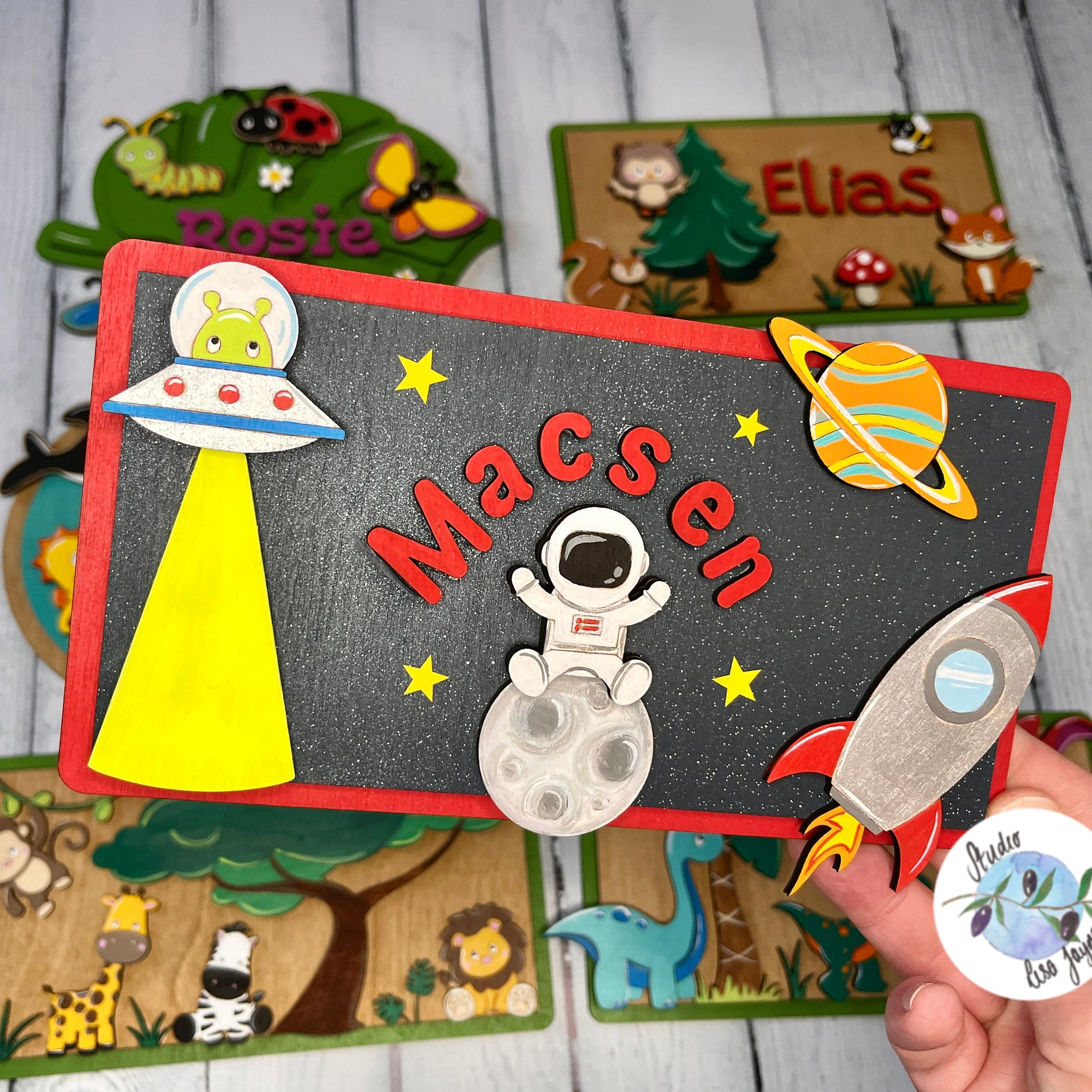 Space Children’s Name Bedroom Door Sign Plaque Personalised Nursery Name - Alien, UFO, Spaceman, Rocket, Planet - in front of woodland animals, bugs, jungle, dinosaurs