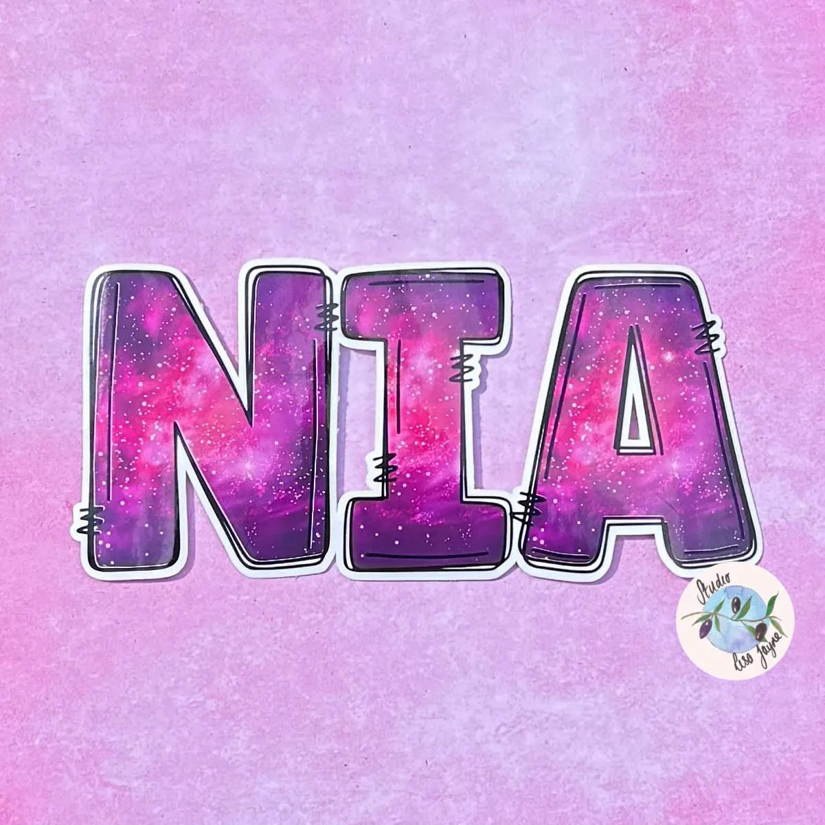 Sticker with 'NIA' in galaxy-themed letters on a pink and purple gradient background.