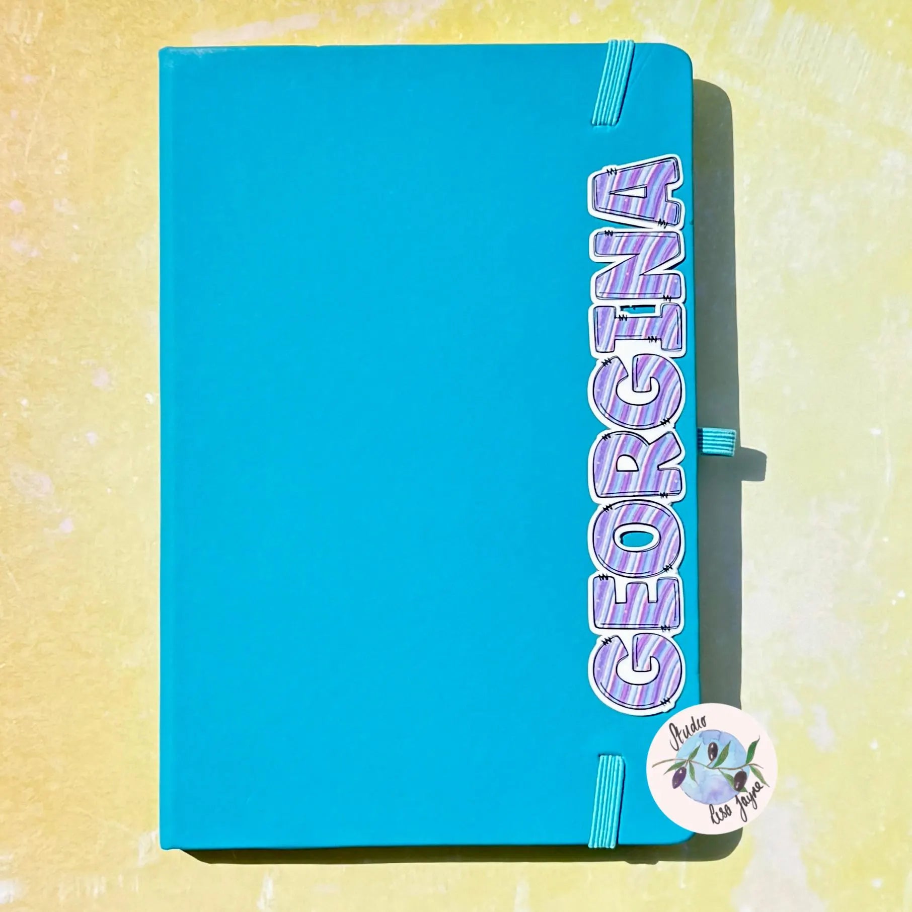 Blue notebook with 'Georgia' space themed sticker