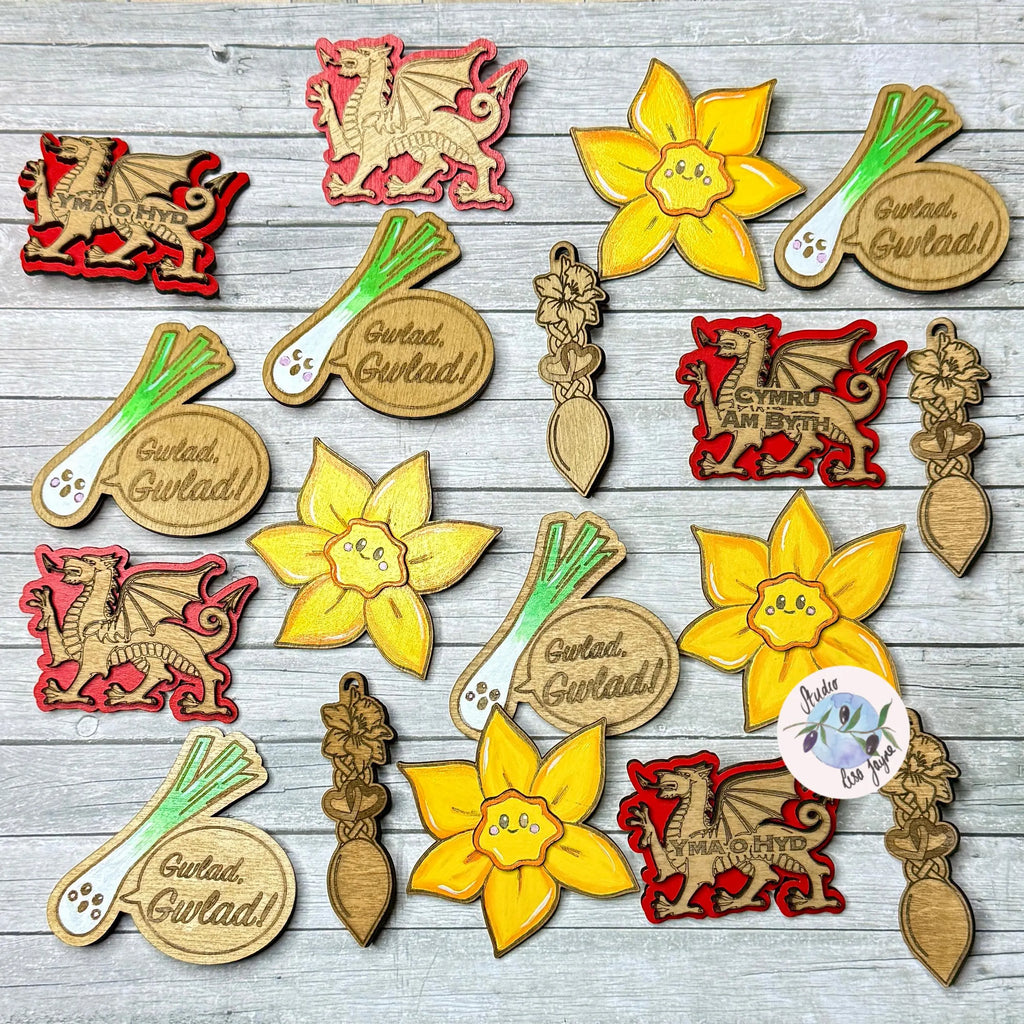 Collection of brooches and badges with daffodils, leeks, dragons, love spoons.  Collection of Studio Lisa Jayne's Welsh brooches made in Swansea