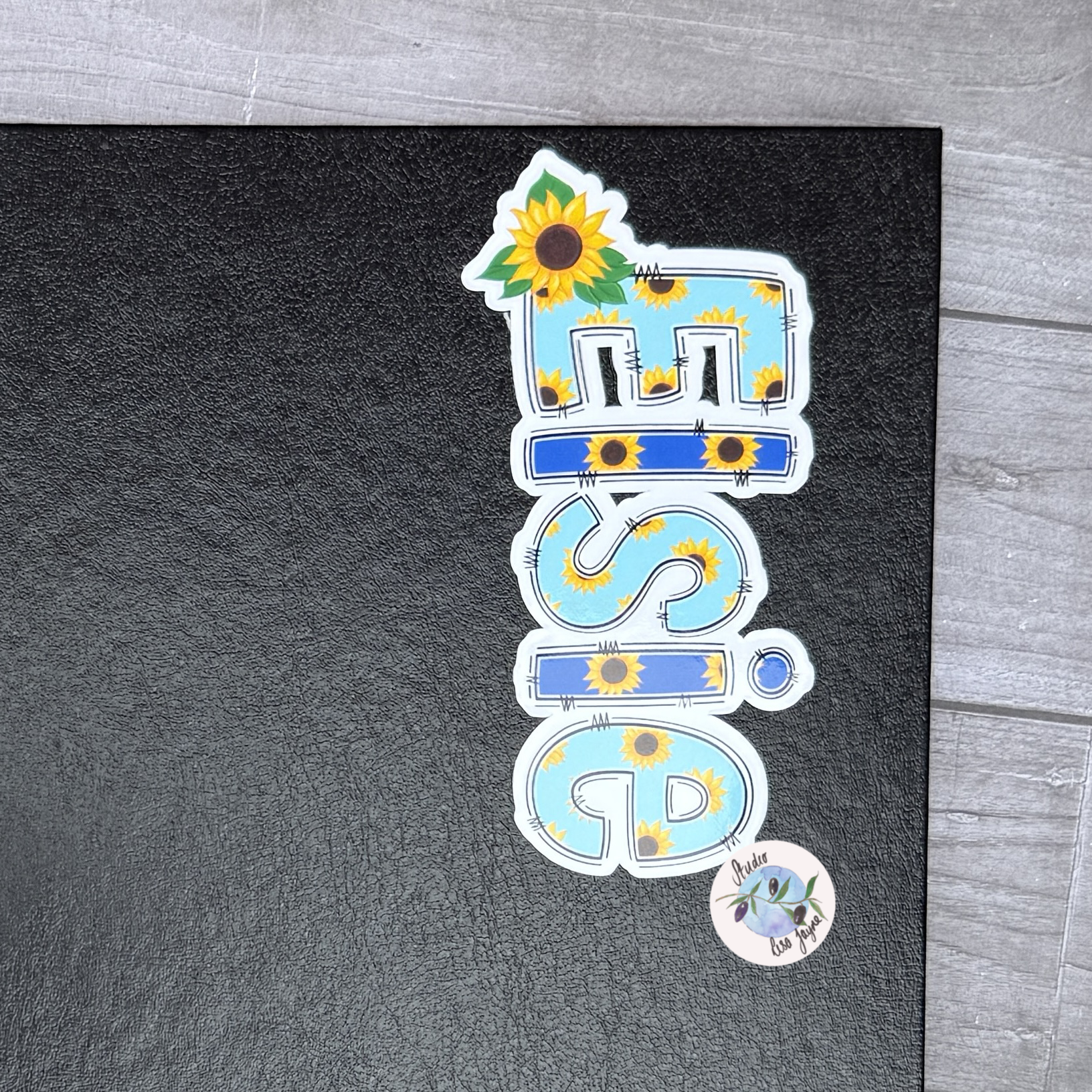 Name Sticker with sunflower design on a black journal