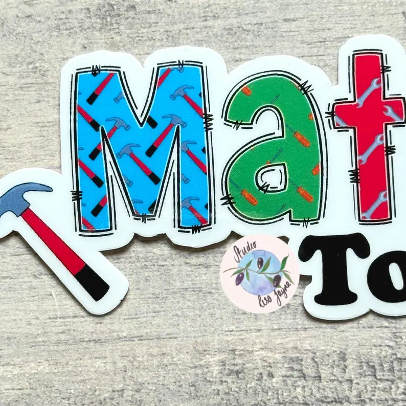 Colorful letter stickers spelling 'Matt' on a textured surface.  Hammer, Screwdriver and spanner themed backgrounds