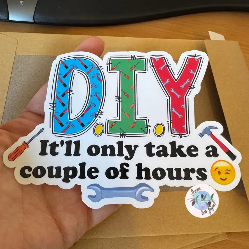 Colorful 'DIY' sticker with text held over a brown envelope.  Hammer Screwdriver Joke funny