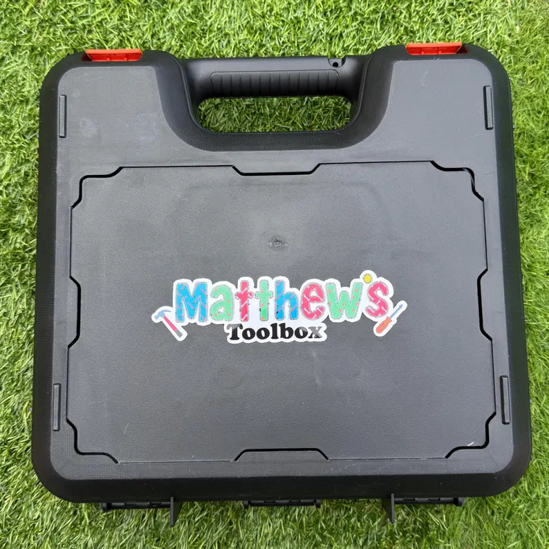 Black toolbox with 'Matthew's Toolbox' personalised name sicker on a grass background
