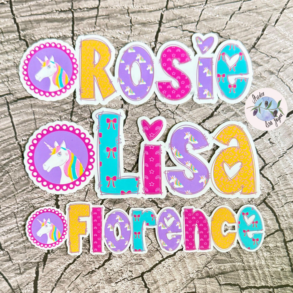 Colourful unicorn name stickers with patterns on a textured surface