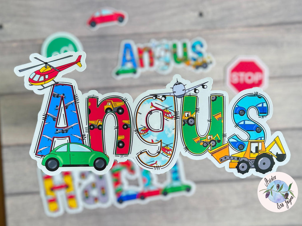 Colorful 'Angus' name sticker with vehicle-themed design on a wooden surface