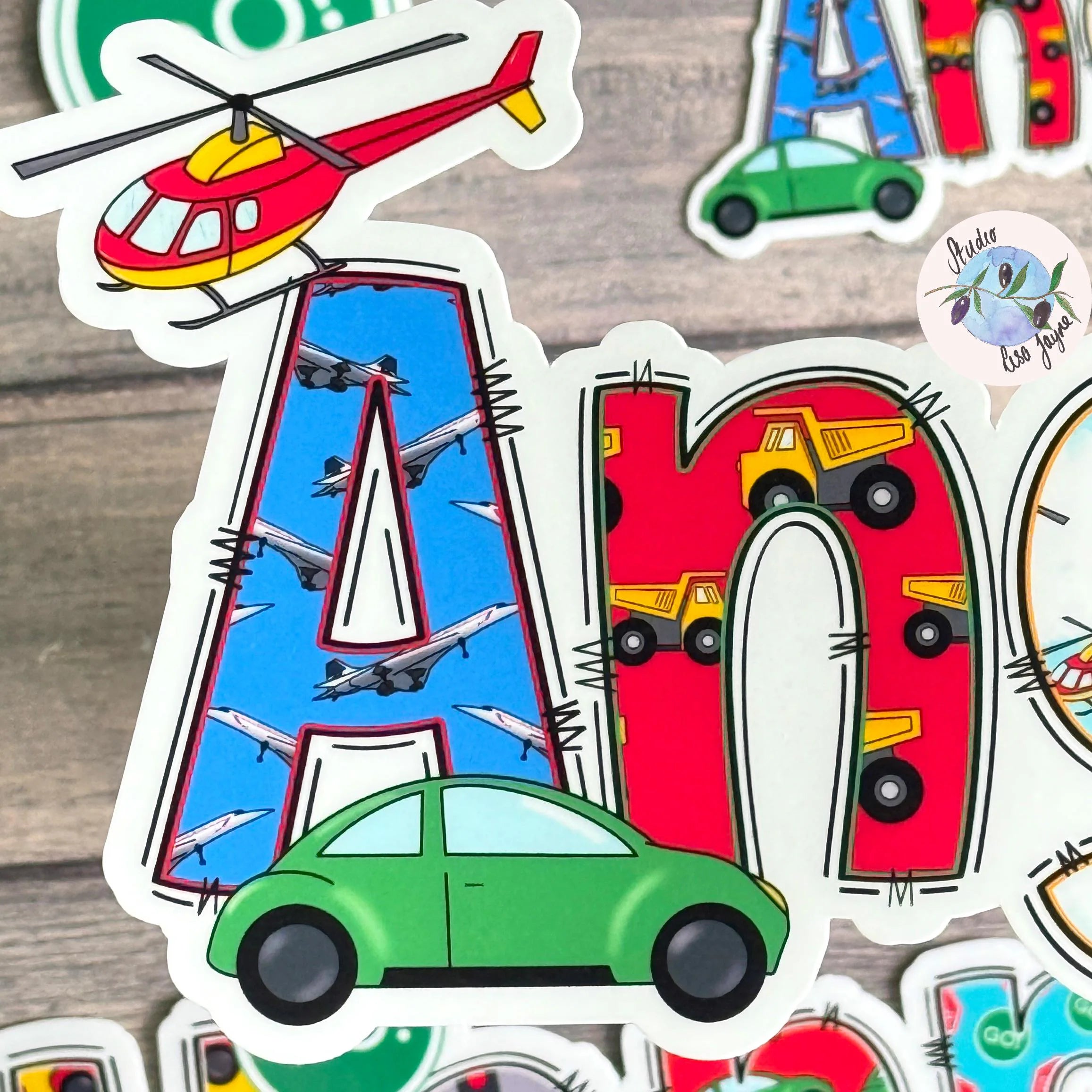 Colorful children's stickers with letters and vehicles on a wooden surface/  Green Car, red helicopter