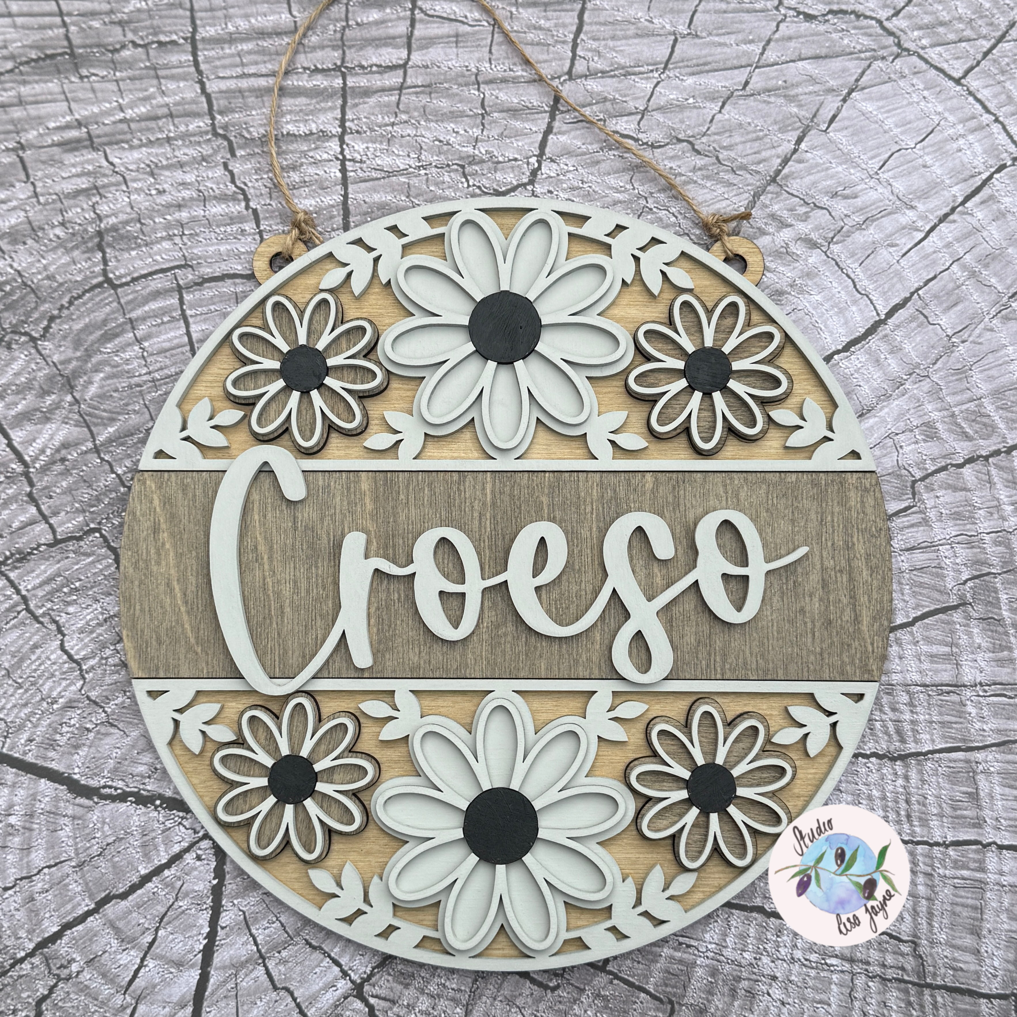 Welcome/Croeso Floral Handmade Hanging Wooden Sign  - Grey wood stain centre with cream and dark grey chalk paint flower.  On a simple wood stump background