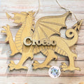 Wooden dragon ornament with 'Croeso' on a wooden surface