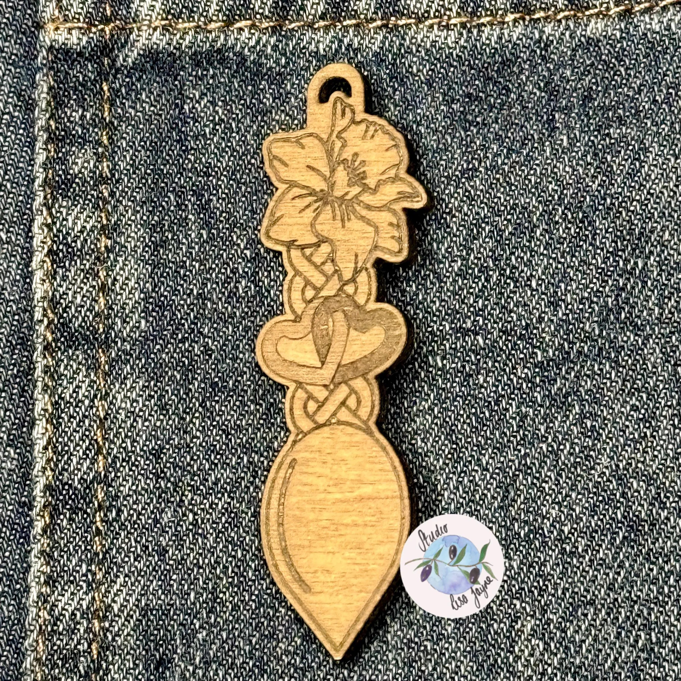 Wooden brooch with floral design on a denim background.  Ideal for St David's Day