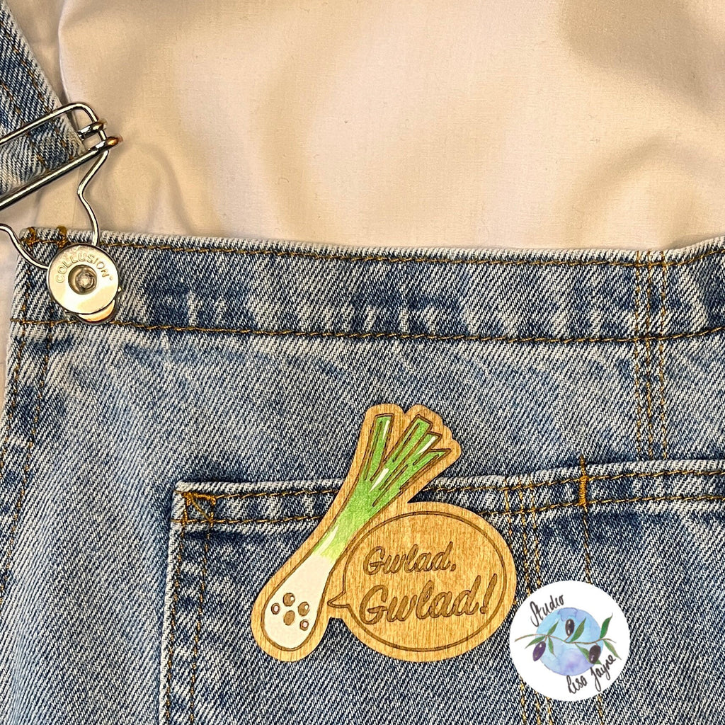 Welsh Singing Leek Wooden Brooch applied to denim dungarees