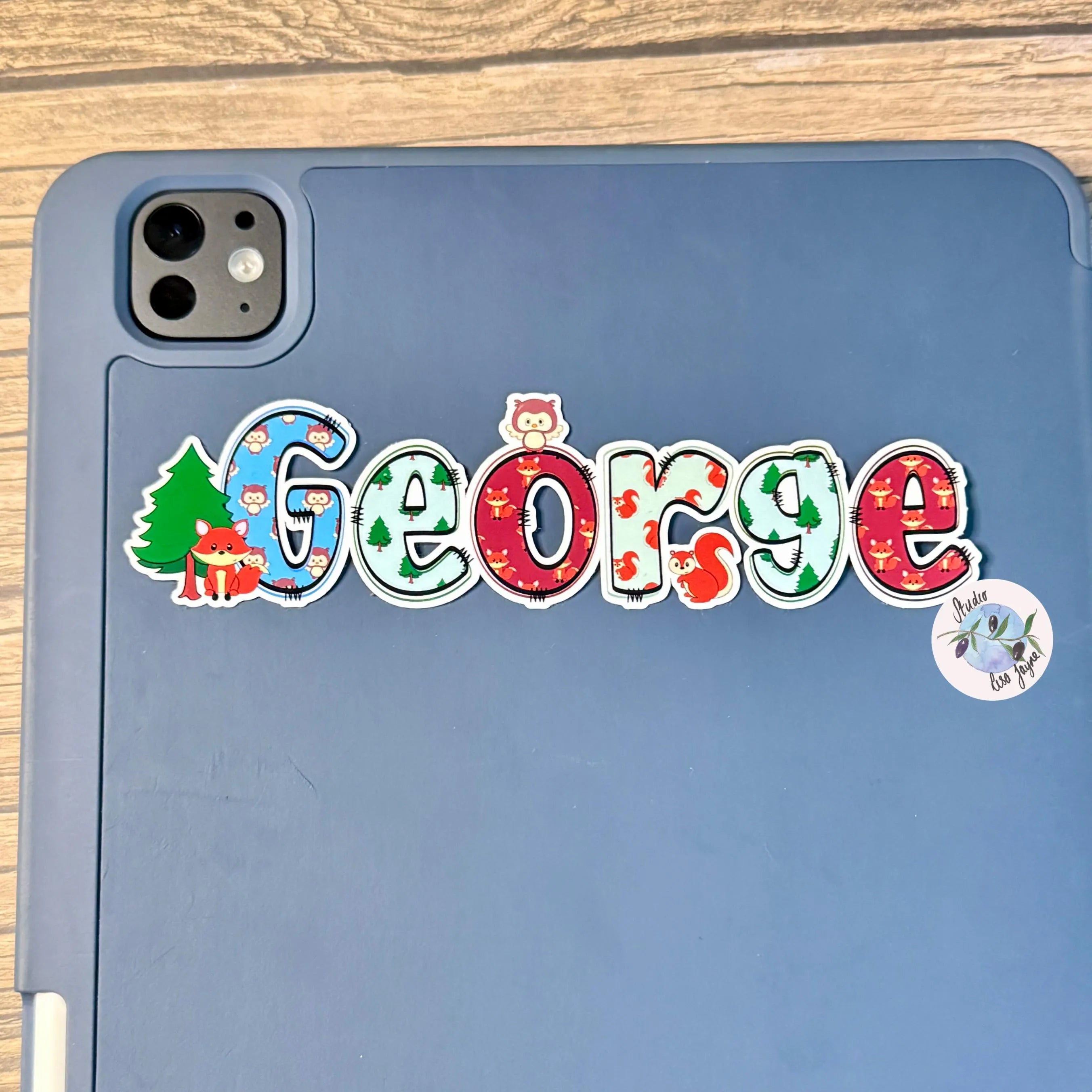 Blue tablet case with 'George' personalised name decal in a woodland theme