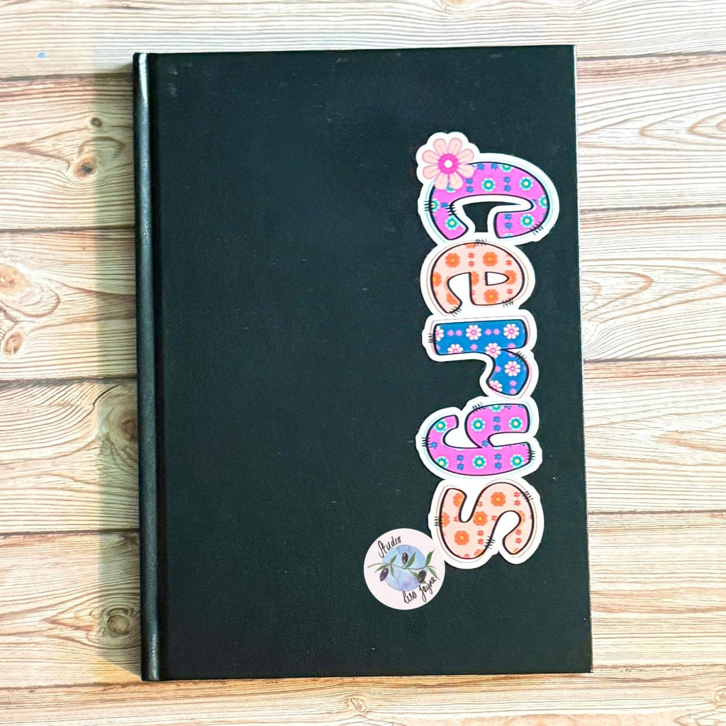 Retro Floral Personalised Name Waterproof Vinyl Sticker For Smooth Surfaces - a black book with colorful letters on it