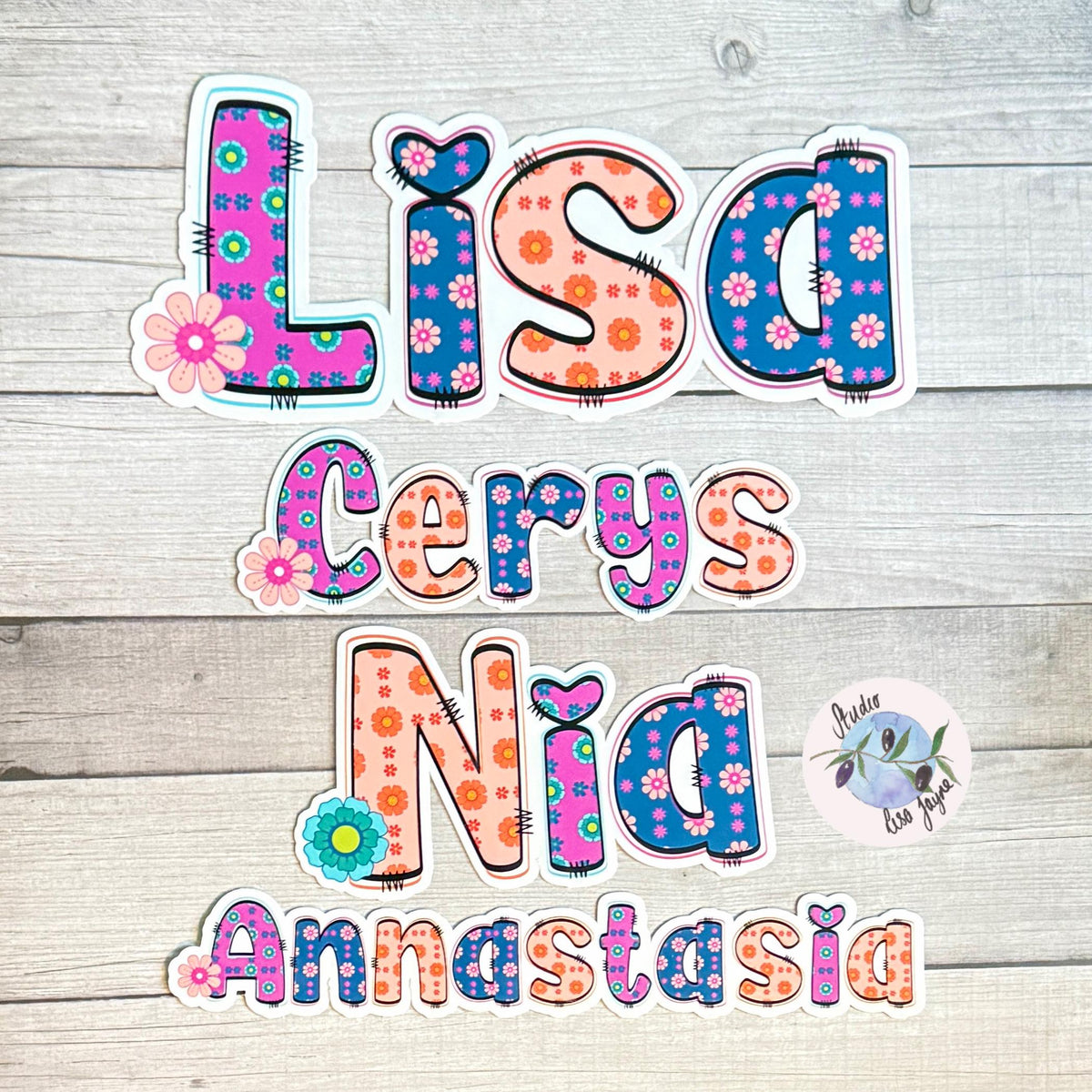 Retro Floral Personalised Name Waterproof Vinyl Sticker For Smooth Surfaces - a group of colorful letters on a wood surface
