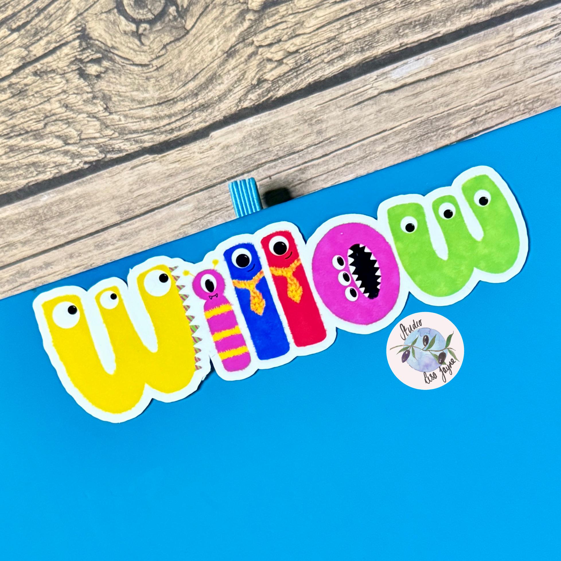 Monster Name Sticker for Smooth Surfaces - a blue sign with a clip on it