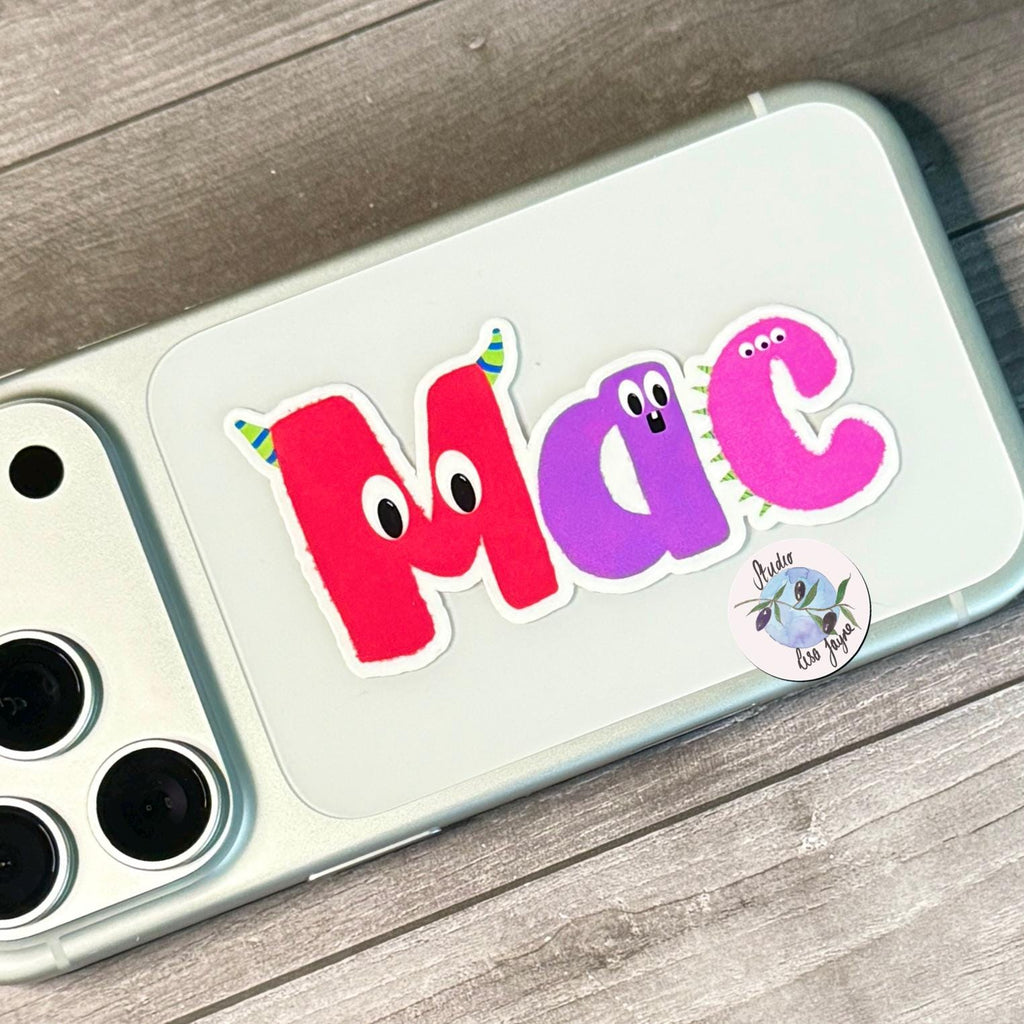Monster Name Sticker for Smooth Surfaces - a cell phone with stickers on it