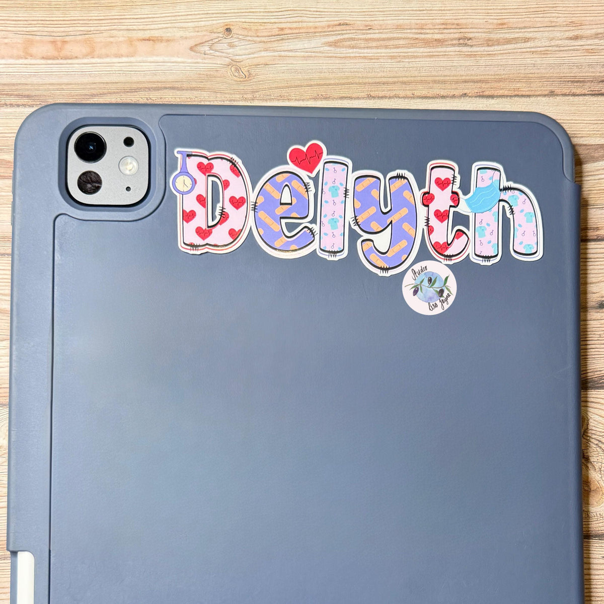 Nurse Healthcare Assistant Personalised Name Waterproof Vinyl Sticker For Smooth Surfaces - a close up of an iPad with Delyth 