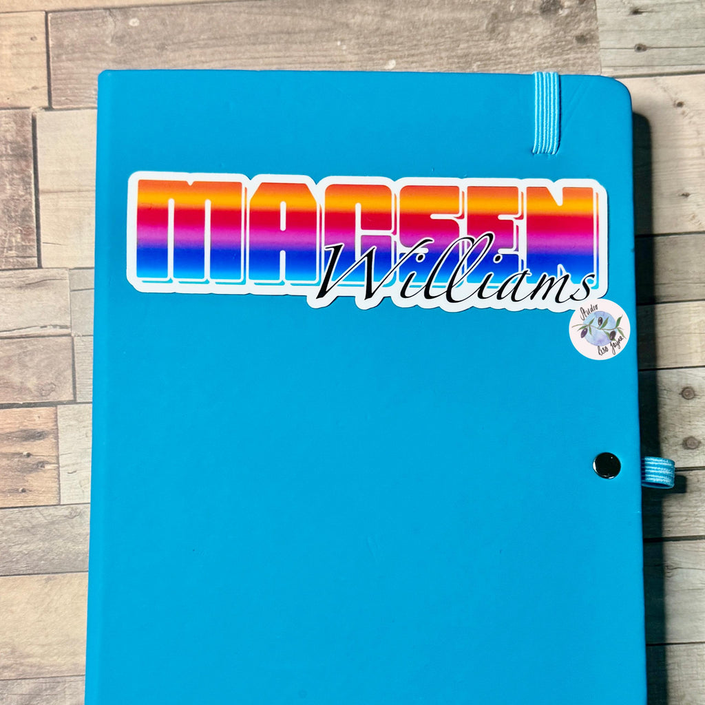 Bright Ombré multicoloured Personalised Name Waterproof Vinyl Sticker For Smooth Surfaces - a blue notebook with a rainbow logo on it