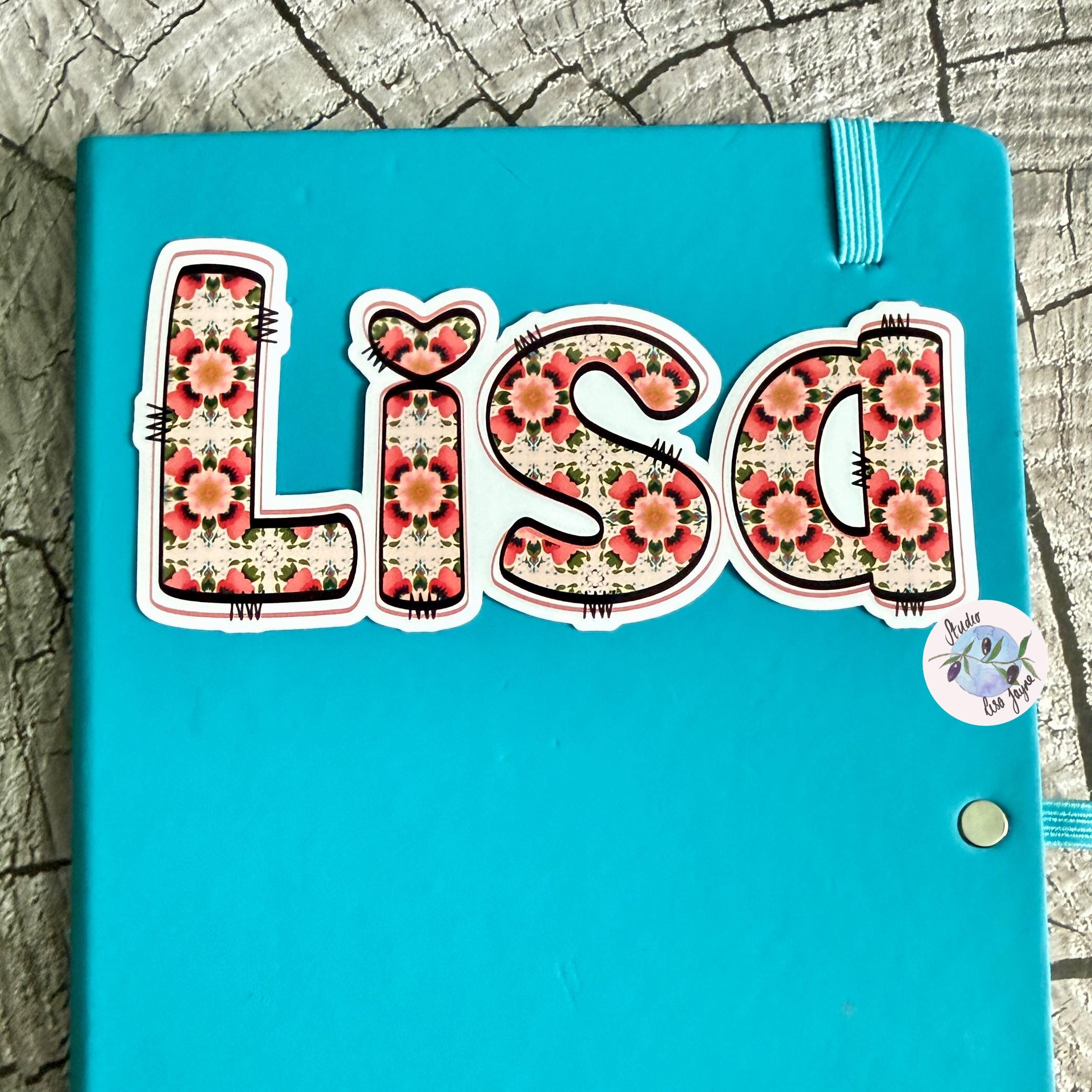 Floral Tile Name Sticker Label on blue notebook diary