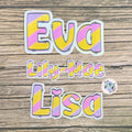 Pastel Rainbow Name Sticker Label - a group of colorful name stickers on a wood surface