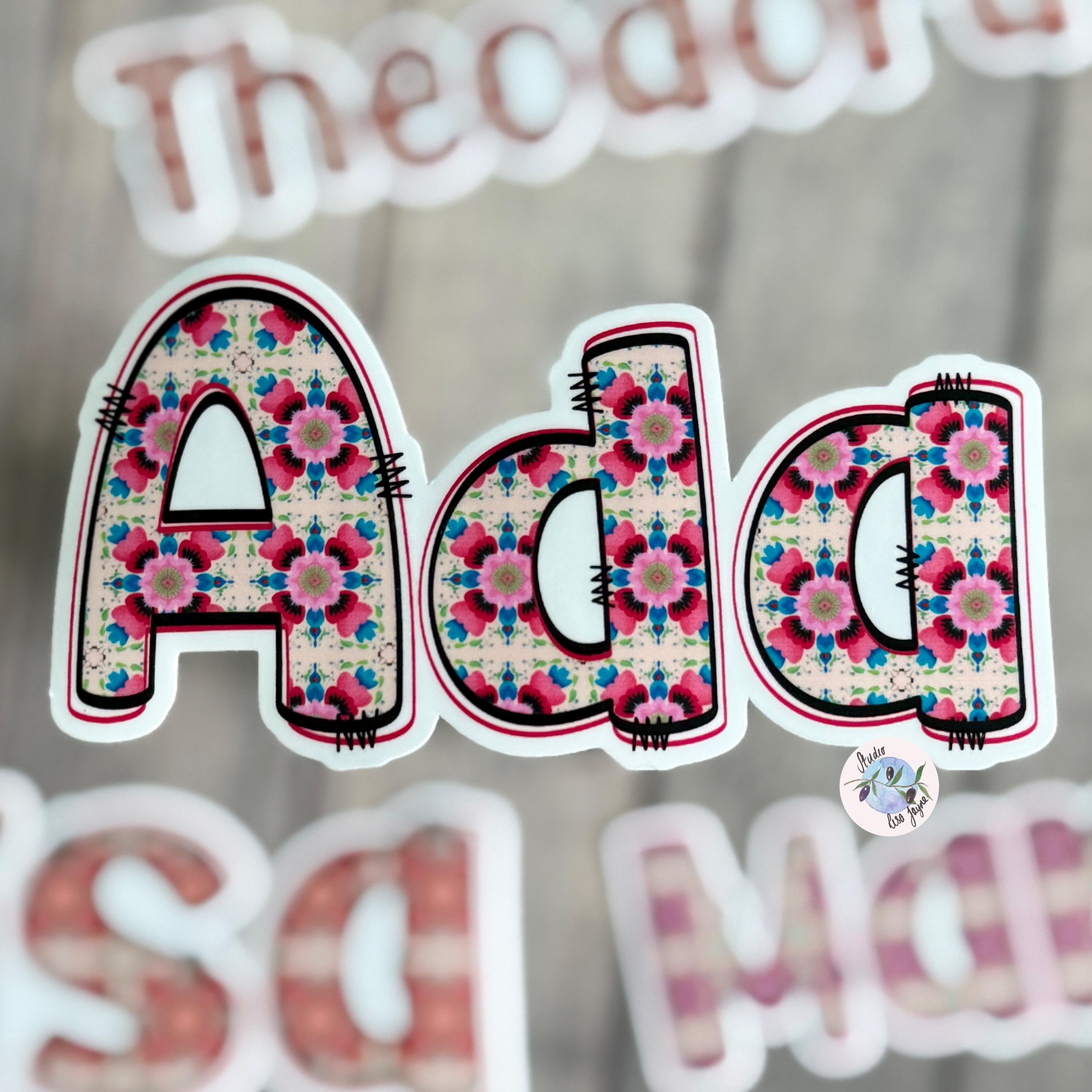 Floral Tile Name Sticker Label Ada with other names blurred in the background