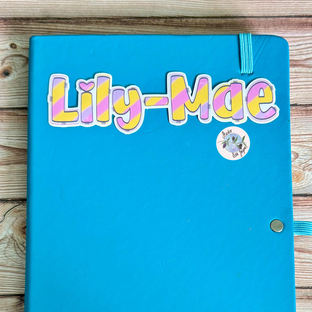 Pastel Rainbow Name Sticker Label - a blue notebook with a name tag on it