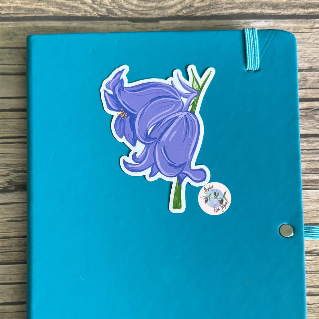 Bluebells Hand Illustrated Waterproof Vinyl Sticker - a blue notebook with a sticker on it