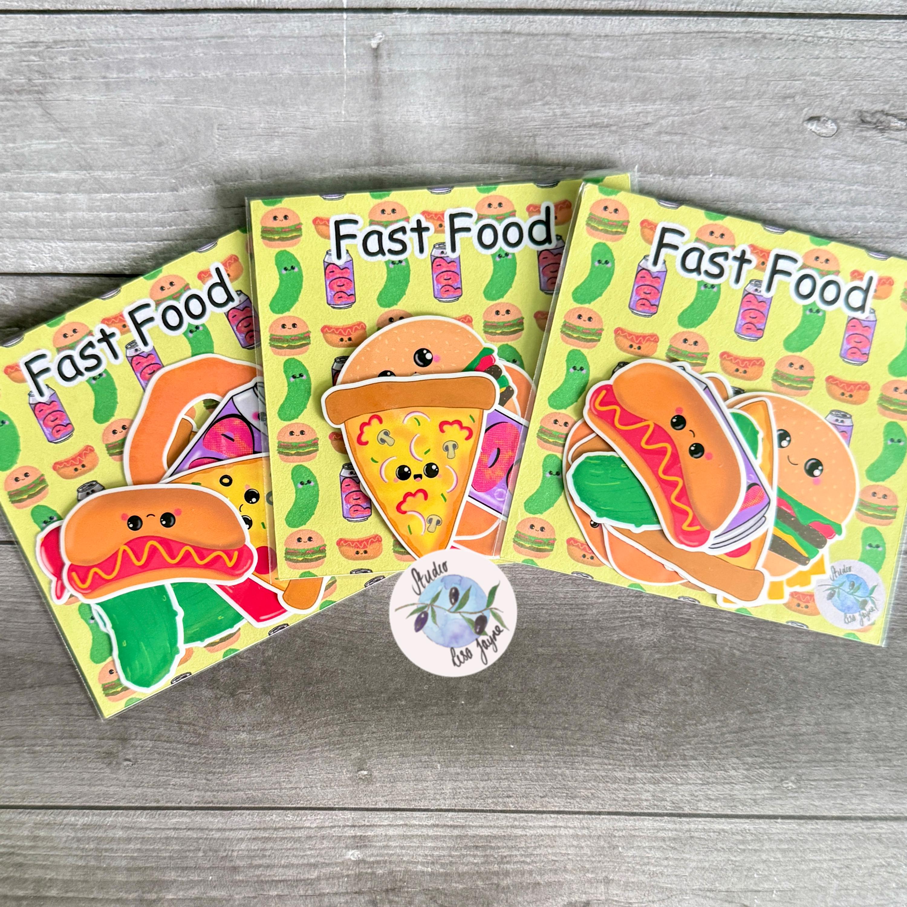 Fast Food Sticker Pack Hand Illustrated Happy Foods - a group of books on a wood surface
