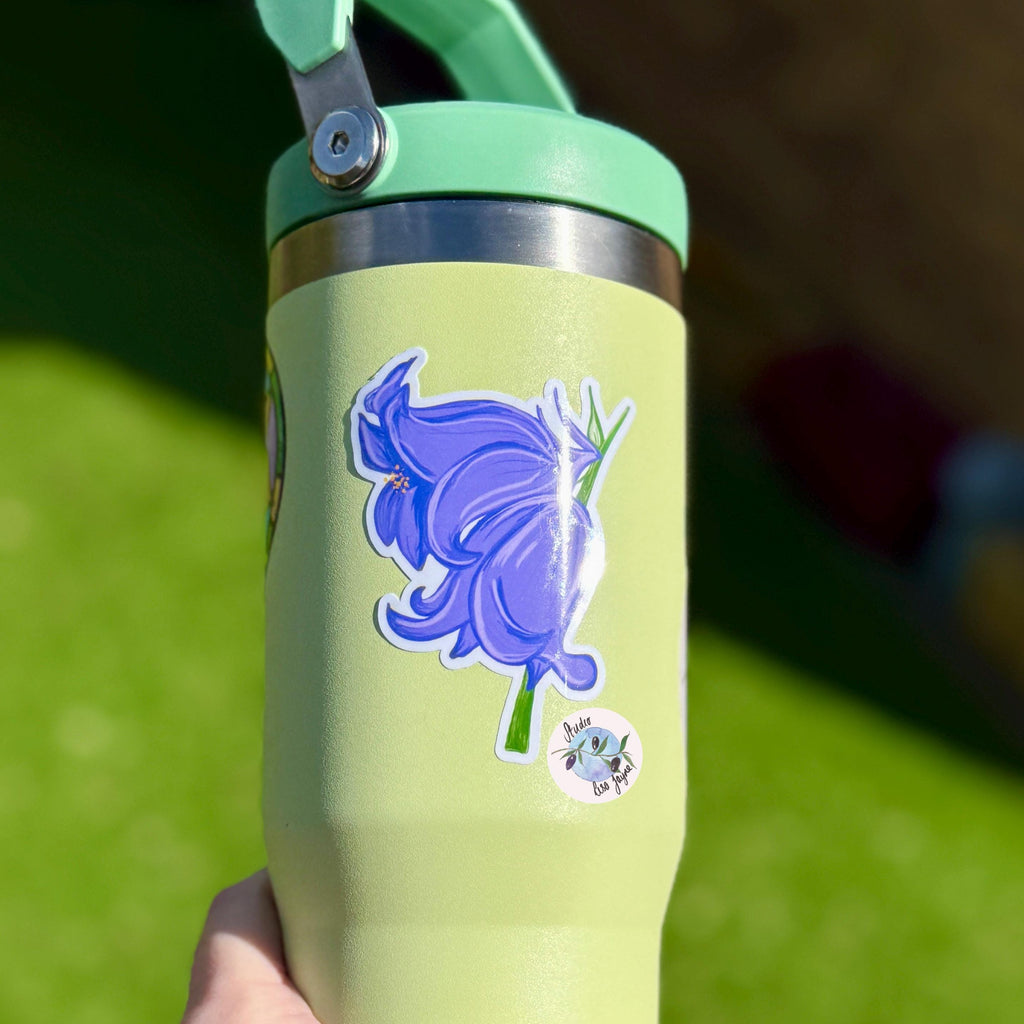 Bluebells Hand Illustrated Waterproof Vinyl Sticker - a person holding a green and purple water bottle