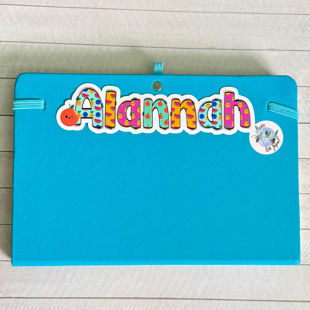 Cute Fruit Name Sticker for Smooth Surfaces - a blue notebook with a name on it