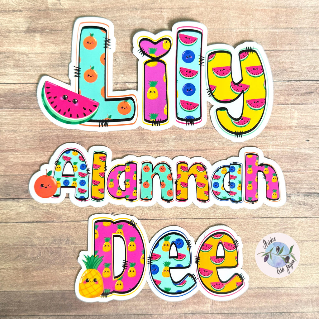 Cute Fruit Name Sticker for Smooth Surfaces - a group of colorful letters and numbers on a wood surface