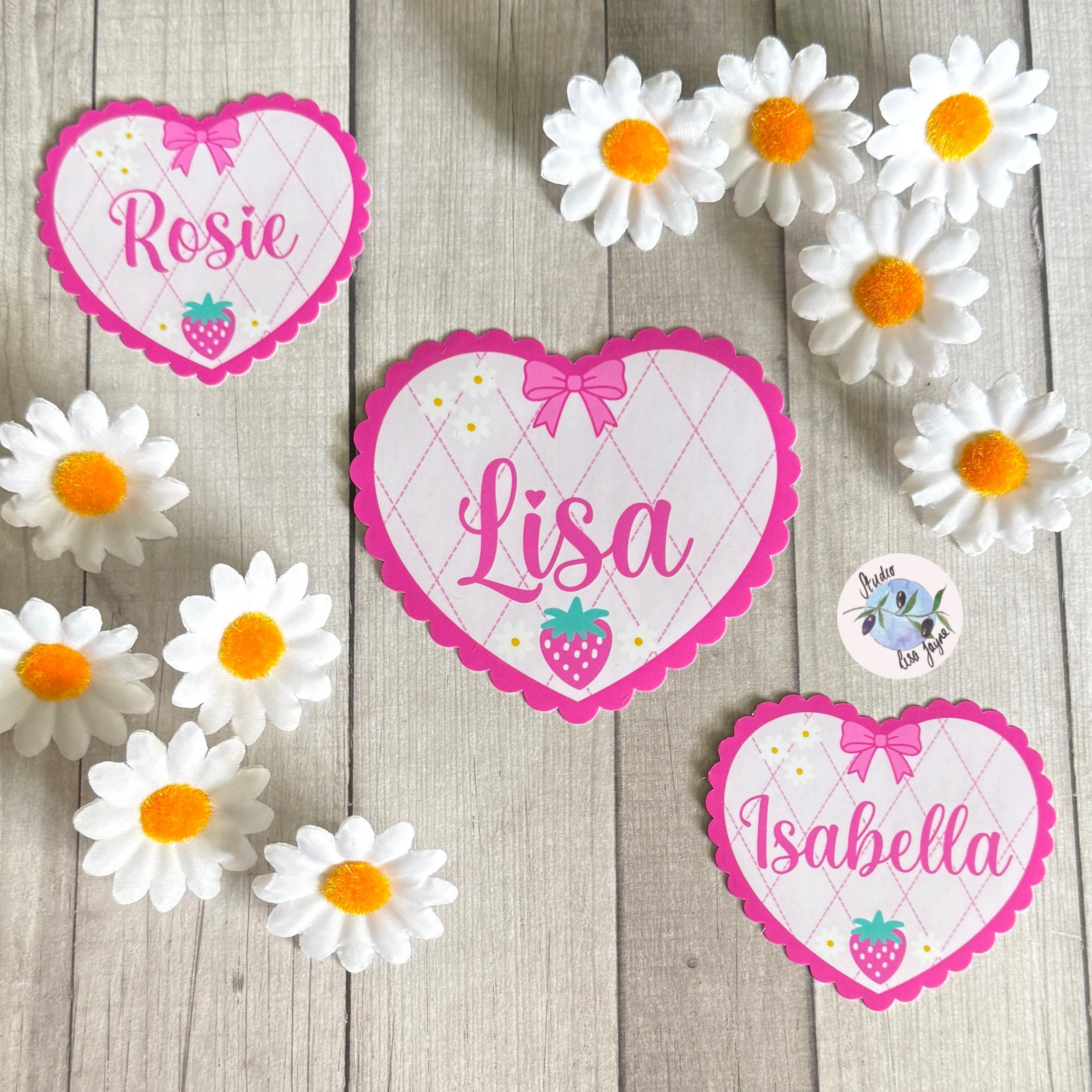 Coquette Strawberry Name Sticker Label Kids - a group of heart shaped girly name stickers on a wood surface
