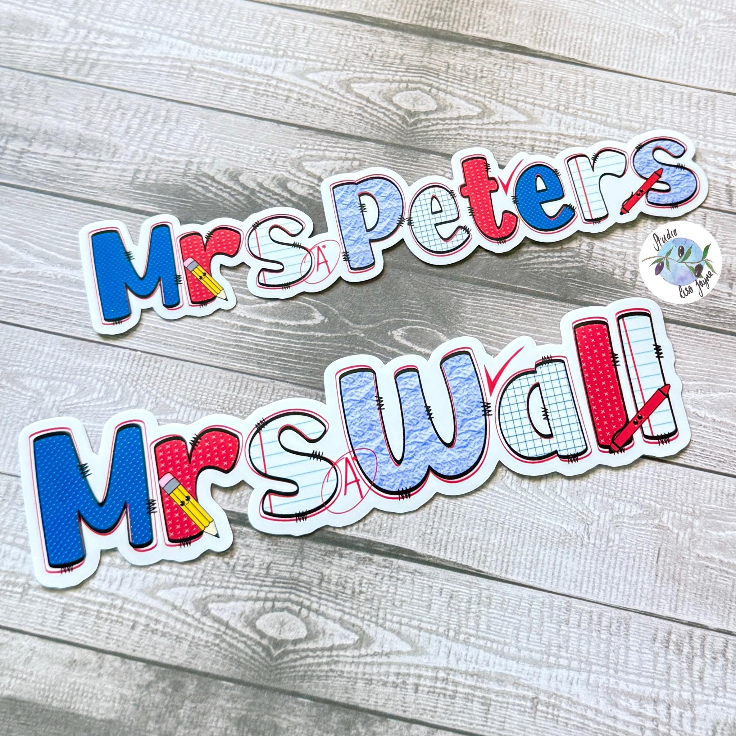 Teacher Name Sticker Label - a sign on a wood surface
