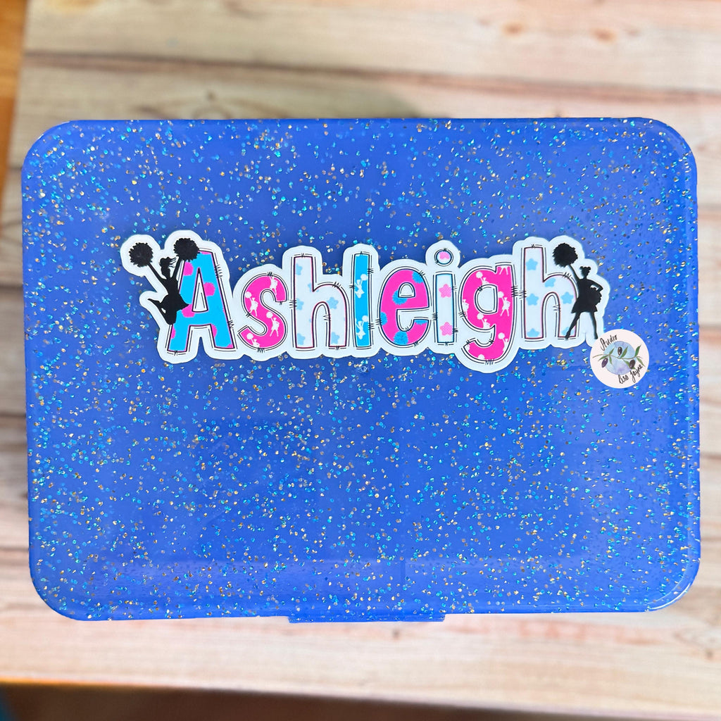 Cheerleader Name Sticker Label - a blue lunch box with Ashleigh name on it