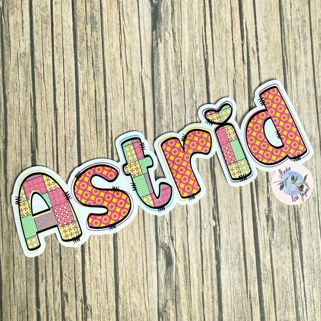 Patchwork Style Name Sticker Label - a colorful name sticker on a wood surface