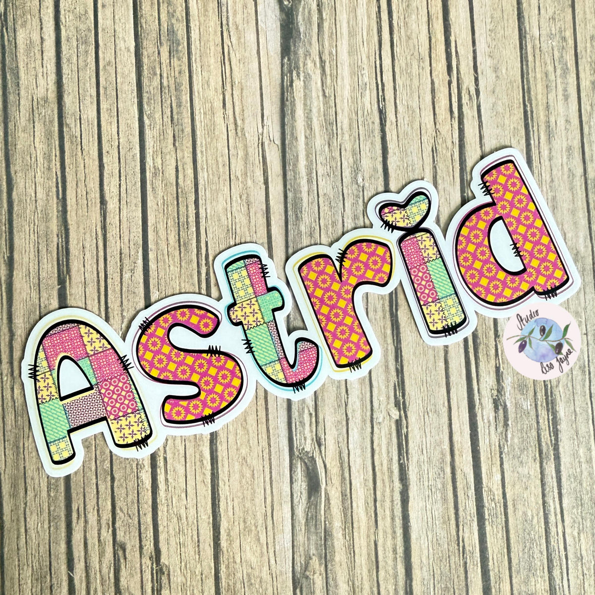 Patchwork Style Name Sticker Label - a colorful name sticker on a wood surface