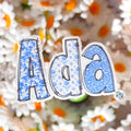 Floral Blue and White Name Sticker Label Kids - a blue and white sticker with flowers.  Ada