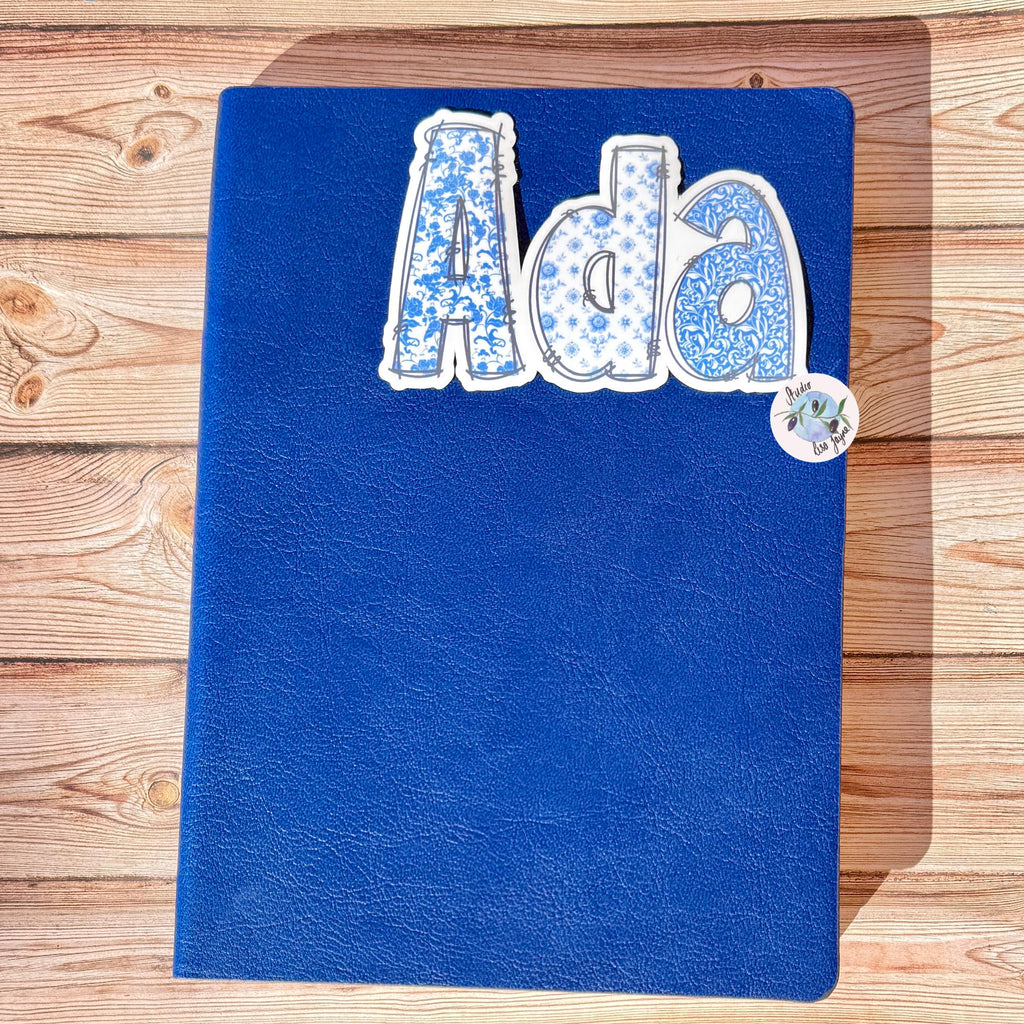 Floral Blue and White Name Sticker Label Kids - a blue notebook with a white and blue floral text on it