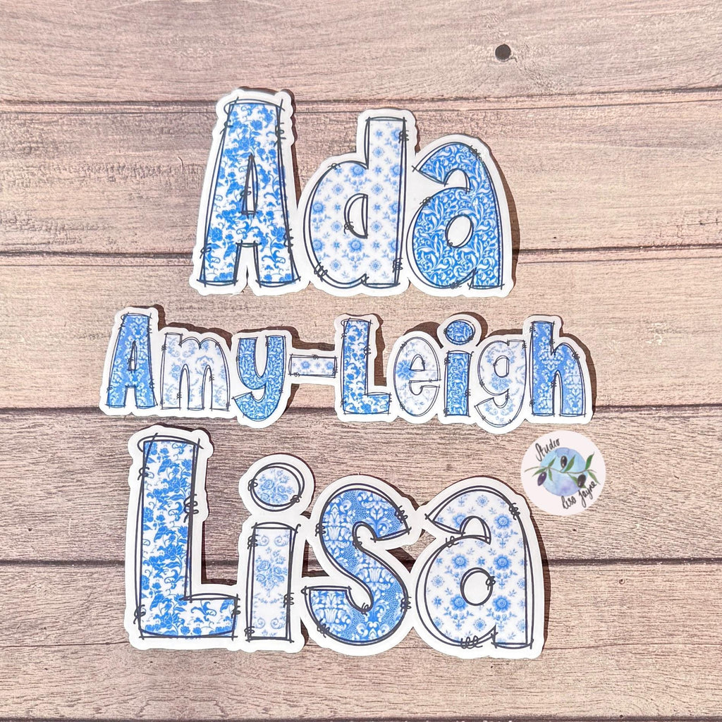 Floral Blue and White Name Sticker Label Kids - a blue and white sticker collection on a wood surface.  Lisa, Amy-Leigh, ADA