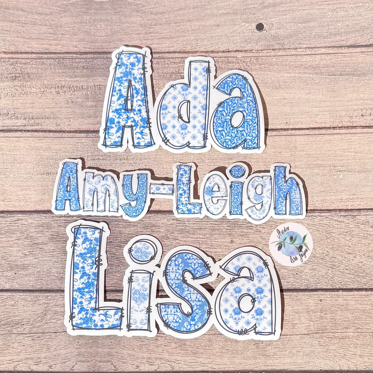Floral Blue and White Name Sticker Label Kids - a blue and white sticker collection on a wood surface.  Lisa, Amy-Leigh, ADA