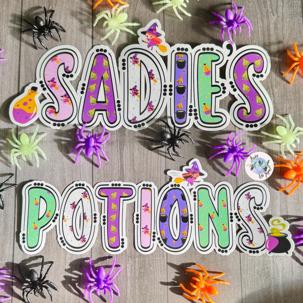 Witches and Potions Halloween Name Sticker Label Kids - a group of plastic spiders on a wood surface