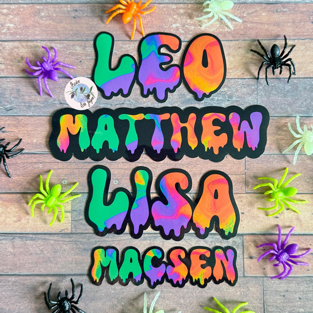 Spooky Drippy Swirly Name Personalised Halloween Waterproof Vinyl Sticker Label - a group of spiders on a wood surface.  Leo, Matthew, Lisa, Macsen