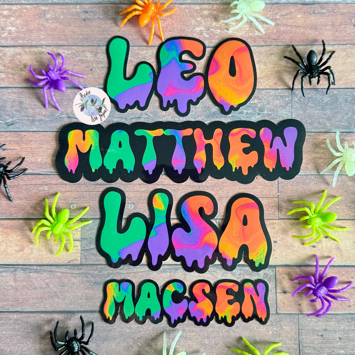 Spooky Drippy Swirly Name Personalised Halloween Waterproof Vinyl Sticker Label - a group of spiders on a wood surface.  Leo, Matthew, Lisa, Macsen