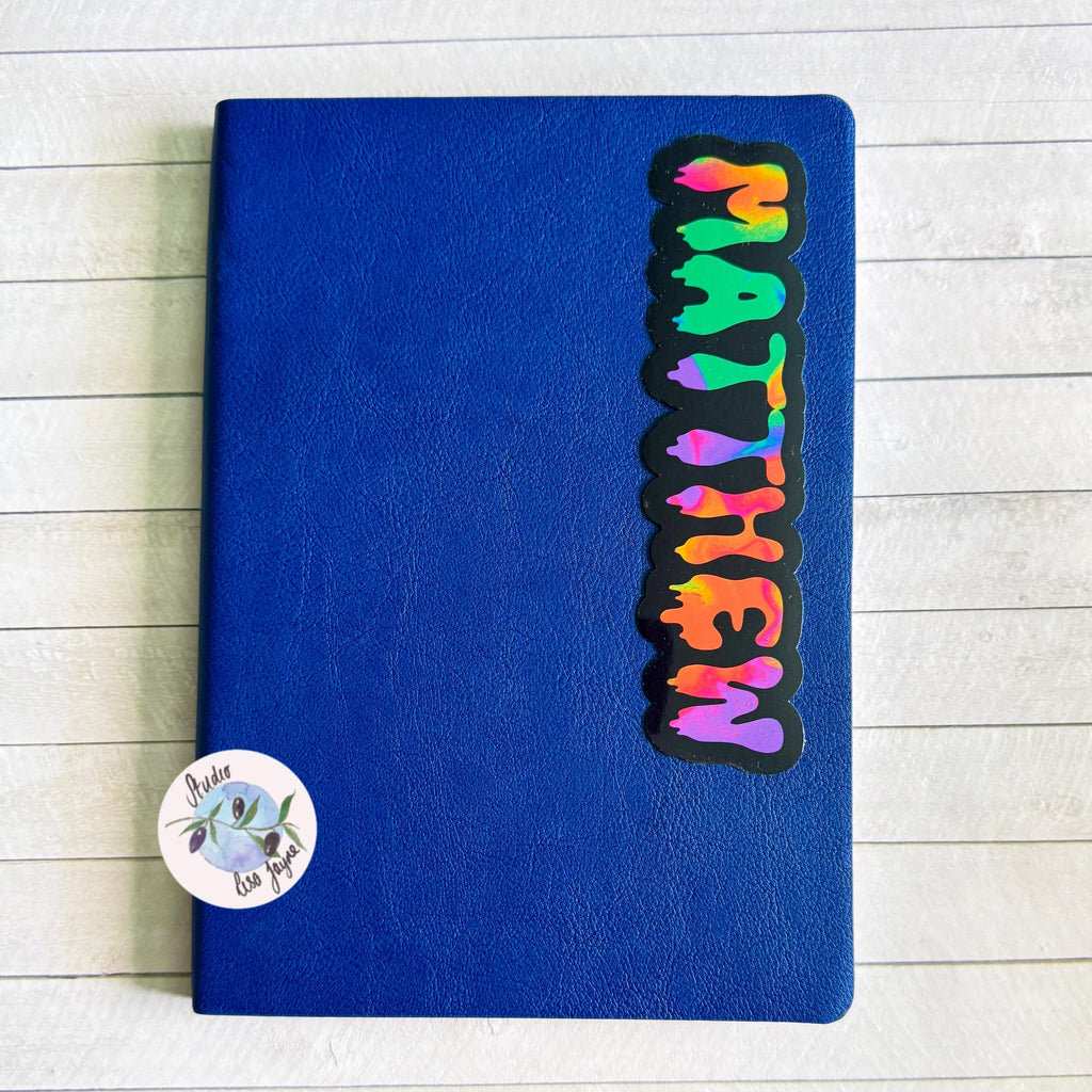 Spooky Drippy Swirly Name Personalised Halloween Waterproof Vinyl Sticker Label - a blue notebook with a Matthew name sticker on it